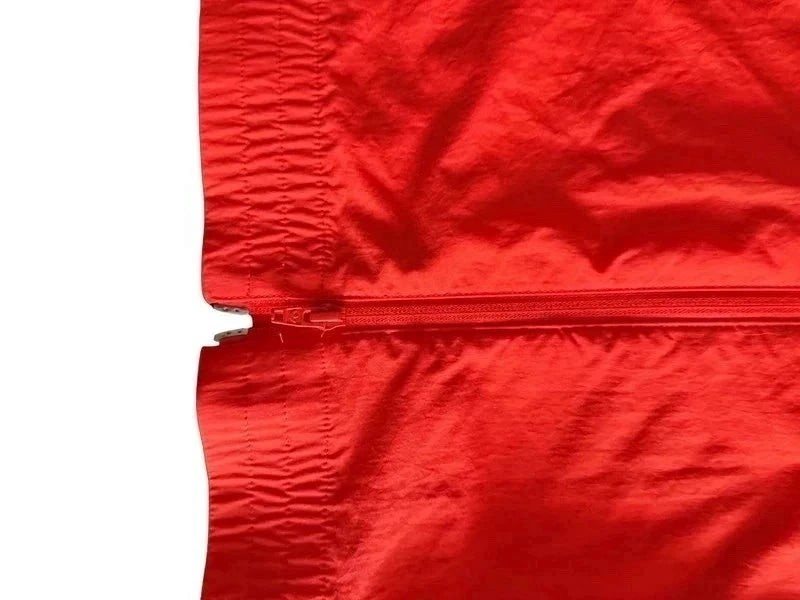 TrickandChic pomarańczowa wiatrówka Adidas Originals z ortalionu z widocznym zamkiem błyskawicznym i ściągaczem